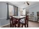 Cozy dining area with a marble-topped table, wooden chairs, and natural light from the window at 51 Brafford Estates Dr, Cameron, NC 28326