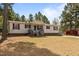 Charming single-story home featuring red shutters, a covered front porch, and mature trees at 51 Brafford Estates Dr, Cameron, NC 28326