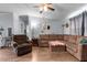 Inviting living room with a sectional sofa, armchair, and wooden floors at 51 Brafford Estates Dr, Cameron, NC 28326