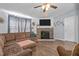 Spacious living room with a large sectional sofa and a stone fireplace feature at 51 Brafford Estates Dr, Cameron, NC 28326