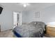 Tranquil main bedroom features a ceiling fan, comfortable bedding, and a doorway to an attached bathroom at 51 Brafford Estates Dr, Cameron, NC 28326