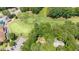 Aerial view of wooded property close to the golf course, club house, and neighborhood parking at 5113 Linksland Dr, Holly Springs, NC 27540