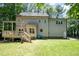Back exterior of home with spacious deck overlooking the backyard at 5113 Linksland Dr, Holly Springs, NC 27540