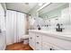 Bright bathroom with double vanity, matte black fixtures, and framed mirror at 5113 Linksland Dr, Holly Springs, NC 27540