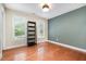 This bedroom features a light fixture, wood floors, and neutral walls at 5113 Linksland Dr, Holly Springs, NC 27540