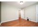 This bedroom features a wood floor, light fixture, and neutral walls at 5113 Linksland Dr, Holly Springs, NC 27540