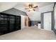 Attic bonus room featuring dark gray accent wall with shelving units and access to other rooms at 5113 Linksland Dr, Holly Springs, NC 27540