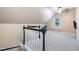 Finished bonus room with black handrail, carpet, and access to stairs at 5113 Linksland Dr, Holly Springs, NC 27540