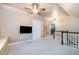 Finished bonus room features neutral walls, carpeting and a ceiling fan at 5113 Linksland Dr, Holly Springs, NC 27540