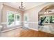 Dining area with lots of natural light from large windows, hardwood floors and views to other rooms at 5113 Linksland Dr, Holly Springs, NC 27540
