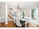 Elegant dining room with hardwood floors, chandelier, and natural light from large windows at 5113 Linksland Dr, Holly Springs, NC 27540