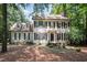 Charming two-story home with black shutters, a brick chimney, and mature landscaping at 5113 Linksland Dr, Holly Springs, NC 27540