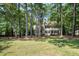 Traditional two-story home surrounded by lush greenery offering privacy and curb appeal at 5113 Linksland Dr, Holly Springs, NC 27540