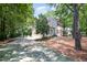 Two-story home features a long driveway and attached garage surrounded by trees and greenery at 5113 Linksland Dr, Holly Springs, NC 27540