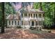Charming two-story home with black shutters, a brick chimney, and mature landscaping at 5113 Linksland Dr, Holly Springs, NC 27540