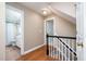 Hallway connecting the rooms of the house, stairs to the upper floor at 5113 Linksland Dr, Holly Springs, NC 27540