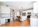 Open kitchen boasts white cabinets, an island with barstool seating, and stainless steel appliances at 5113 Linksland Dr, Holly Springs, NC 27540
