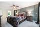 This main bedroom has a decorative wall, ceiling fan, and a large bed at 5113 Linksland Dr, Holly Springs, NC 27540