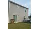 View of the backyard with sliding door, fair lawn, and an umbrella with table set at 512 Crow Field St, Roxboro, NC 27574