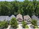 Aerial view of a neighborhood showcasing rooftops, mature trees, and well-maintained lawns, highlighting the community's appeal at 512 Mill Hopper Ln, Apex, NC 27502
