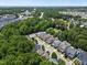 A beautiful aerial view of a residential neighborhood surrounded by lush trees and landscaping at 512 Mill Hopper Ln, Apex, NC 27502