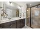 Beautiful bathroom featuring a double vanity, framed mirror, granite countertop, and tiled glass door shower at 512 Mill Hopper Ln, Apex, NC 27502