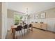 Well-lit dining room featuring a wooden table and buffet, with natural light at 512 Mill Hopper Ln, Apex, NC 27502