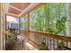 Inviting screened porch with wood floors and a beautiful view of the surrounding trees and greenery at 512 Mill Hopper Ln, Apex, NC 27502