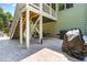Backyard patio area featuring stairs leading up to the deck and outdoor seating at 529 Lake Gaston Dr, Fuquay Varina, NC 27526