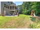 Lush backyard showcasing an outdoor patio, play set, and ample green space for recreation and relaxation at 529 Lake Gaston Dr, Fuquay Varina, NC 27526