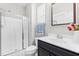 Bathroom features a walk-in shower with glass door, white toilet, and a vanity with fresh flowers at 529 Lake Gaston Dr, Fuquay Varina, NC 27526