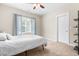 Bright bedroom featuring a ceiling fan, window with blue curtains, and neutral colored walls at 529 Lake Gaston Dr, Fuquay Varina, NC 27526