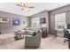 Comfortable bonus room featuring a large sectional sofa, ceiling fan, and wall decor at 529 Lake Gaston Dr, Fuquay Varina, NC 27526