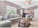 Spacious bonus room includes a large sofa, accent chair, ceiling fan, and a desk at 529 Lake Gaston Dr, Fuquay Varina, NC 27526