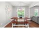 Dining area with a wooden table and benches, a decorative compass, and a view to the backyard at 529 Lake Gaston Dr, Fuquay Varina, NC 27526