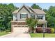 Two-story home with stone accents, attached garage, complemented by manicured landscaping and lush greenery at 529 Lake Gaston Dr, Fuquay Varina, NC 27526