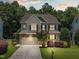 Beautiful two-story home with a stone and siding exterior, attached garage, and professionally landscaped yard at 529 Lake Gaston Dr, Fuquay Varina, NC 27526