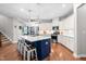 Modern kitchen features stainless steel appliances, white cabinetry, and a center island with seating at 529 Lake Gaston Dr, Fuquay Varina, NC 27526