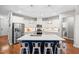 Bright kitchen features white cabinetry, stainless appliances, and a large center island with bar seating at 529 Lake Gaston Dr, Fuquay Varina, NC 27526