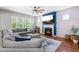 Cozy living room with large sectional sofa, gas fireplace, shiplap accent wall, and natural light at 529 Lake Gaston Dr, Fuquay Varina, NC 27526