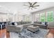 Spacious living room features a large sectional sofa, stylish decor, and hardwood flooring at 529 Lake Gaston Dr, Fuquay Varina, NC 27526