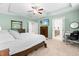 Large main bedroom featuring a bed, dresser, desk, ceiling fan, and ensuite bathroom at 529 Lake Gaston Dr, Fuquay Varina, NC 27526