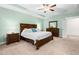 Well-lit main bedroom featuring a large bed, two nightstands, a dresser, and a ceiling fan at 529 Lake Gaston Dr, Fuquay Varina, NC 27526
