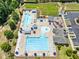 Aerial view showcasing multiple pools and lounge area, playground, and community gathering areas at 529 Lake Gaston Dr, Fuquay Varina, NC 27526
