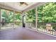 Enclosed porch with views of the wooded backyard and a ceiling fan at 529 Lake Gaston Dr, Fuquay Varina, NC 27526