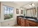 Elegant bathroom featuring double sinks, granite countertops, and a large window with a scenic view at 53 Lake Wendell Rd, Wendell, NC 27591