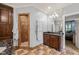 Bathroom features marble countertops, wood cabinets, and a shower with decorative tile border at 53 Lake Wendell Rd, Wendell, NC 27591