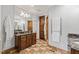Spacious bathroom featuring double sinks, granite countertops, wood cabinets, and shower with decorative tile border at 53 Lake Wendell Rd, Wendell, NC 27591