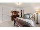 Cozy bedroom with a wrought iron bed, dresser with mirror and warm lighting at 53 Lake Wendell Rd, Wendell, NC 27591