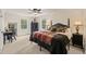 Bedroom with a four-poster bed, dark wood furniture, and two windows with views of trees at 53 Lake Wendell Rd, Wendell, NC 27591